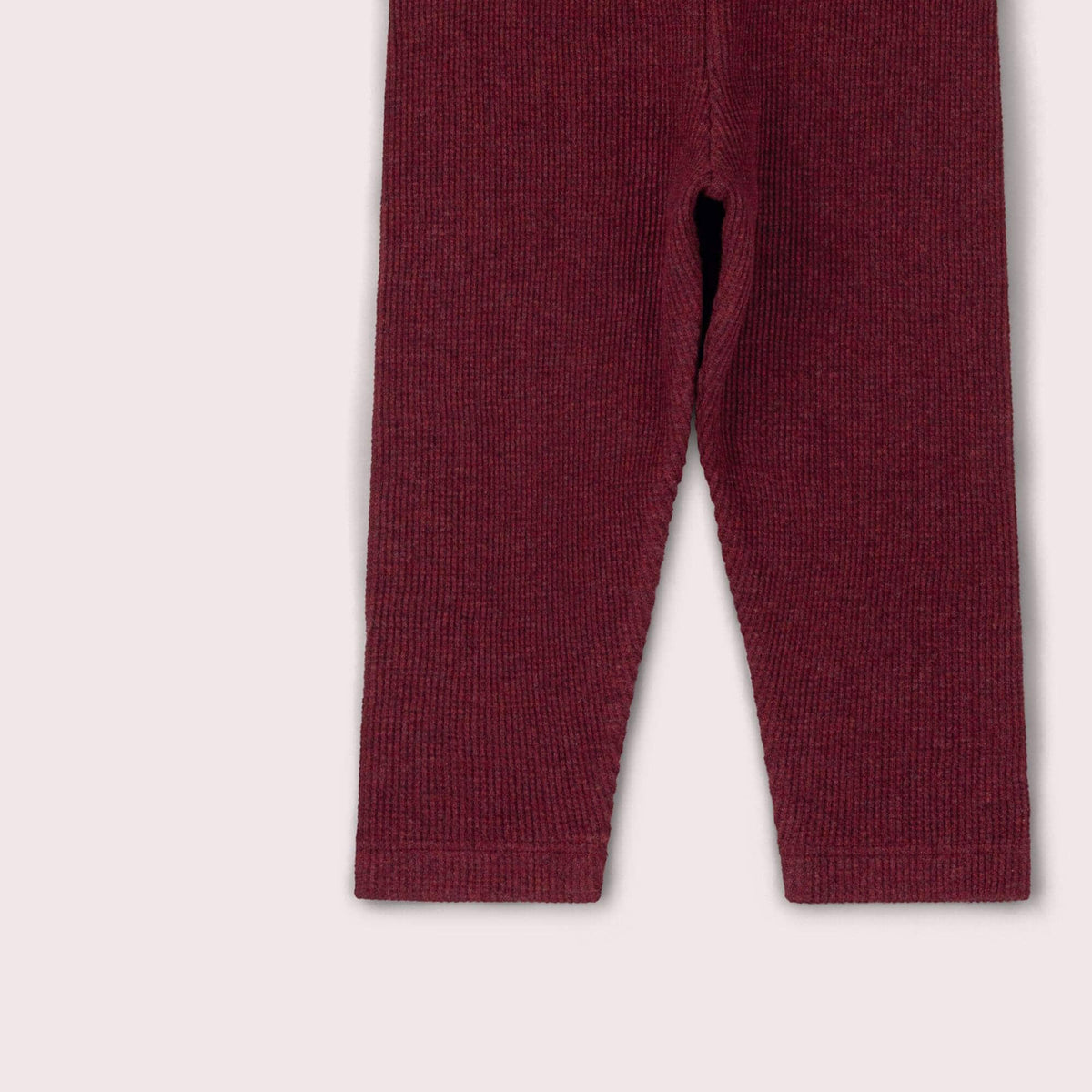 Detail of the tapered legs and stitched ankle hems on burgundy waffle leggings.