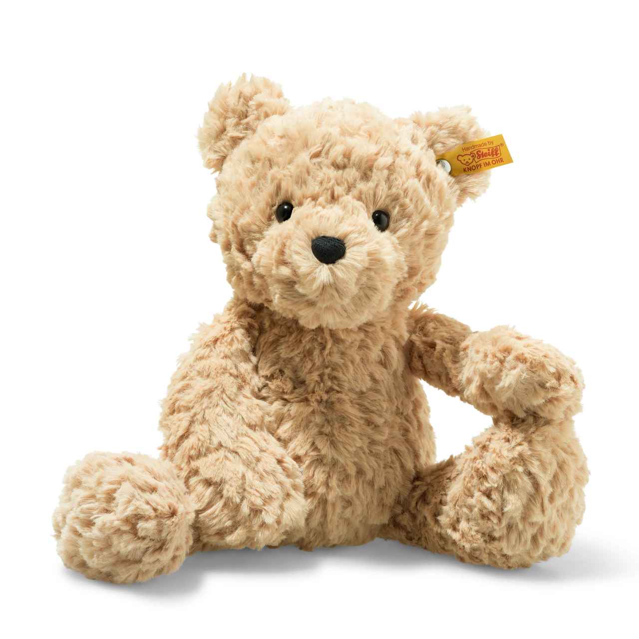 A plush toy of a brown teddy bear with a hood, made from soft fabric, posed with its arm around its knee.