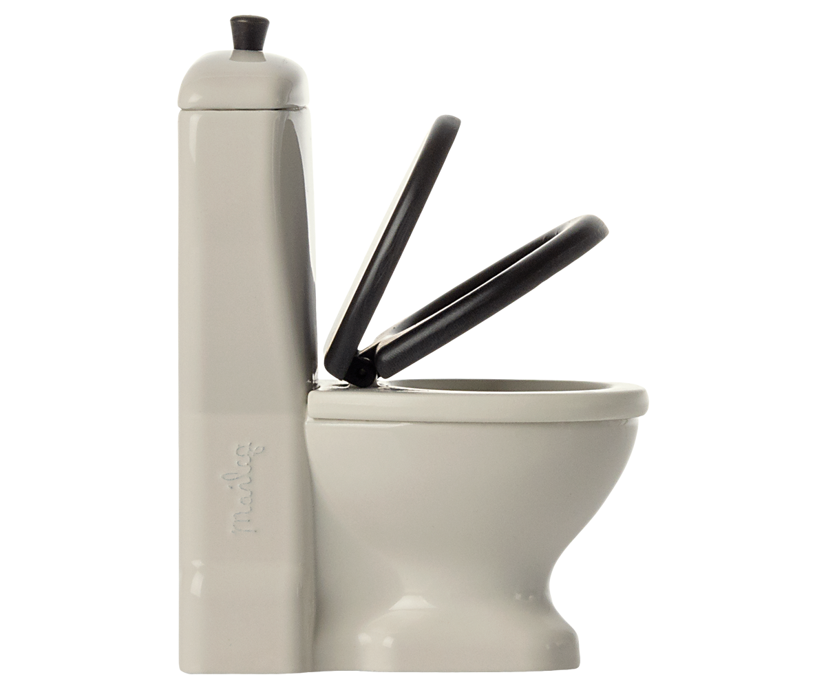White doll sized toilet with a black seat and handle on a white background