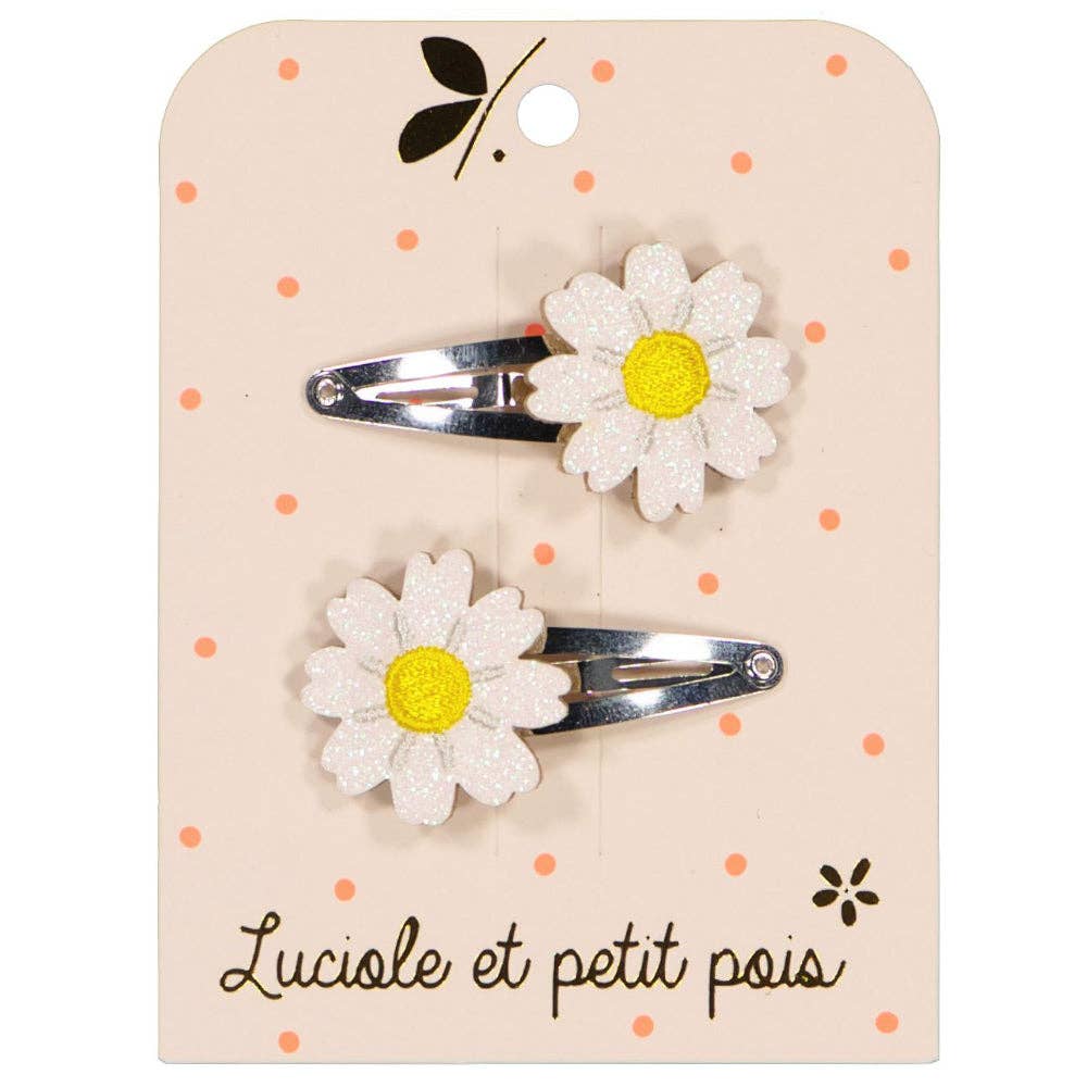 Two flower-shaped hair clips on a branded card with 'Luciole et petit pois' text.