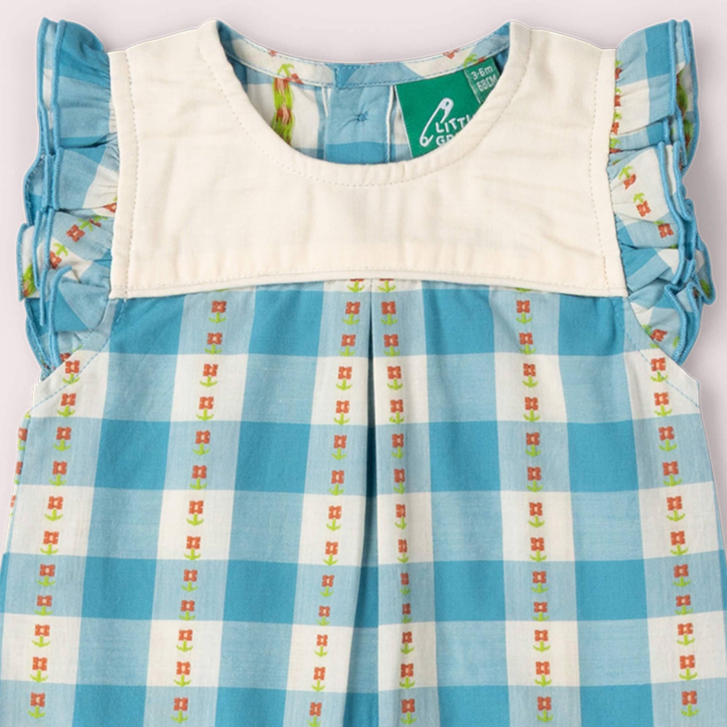 Blue and white checkered dress with floral patterns on a white background