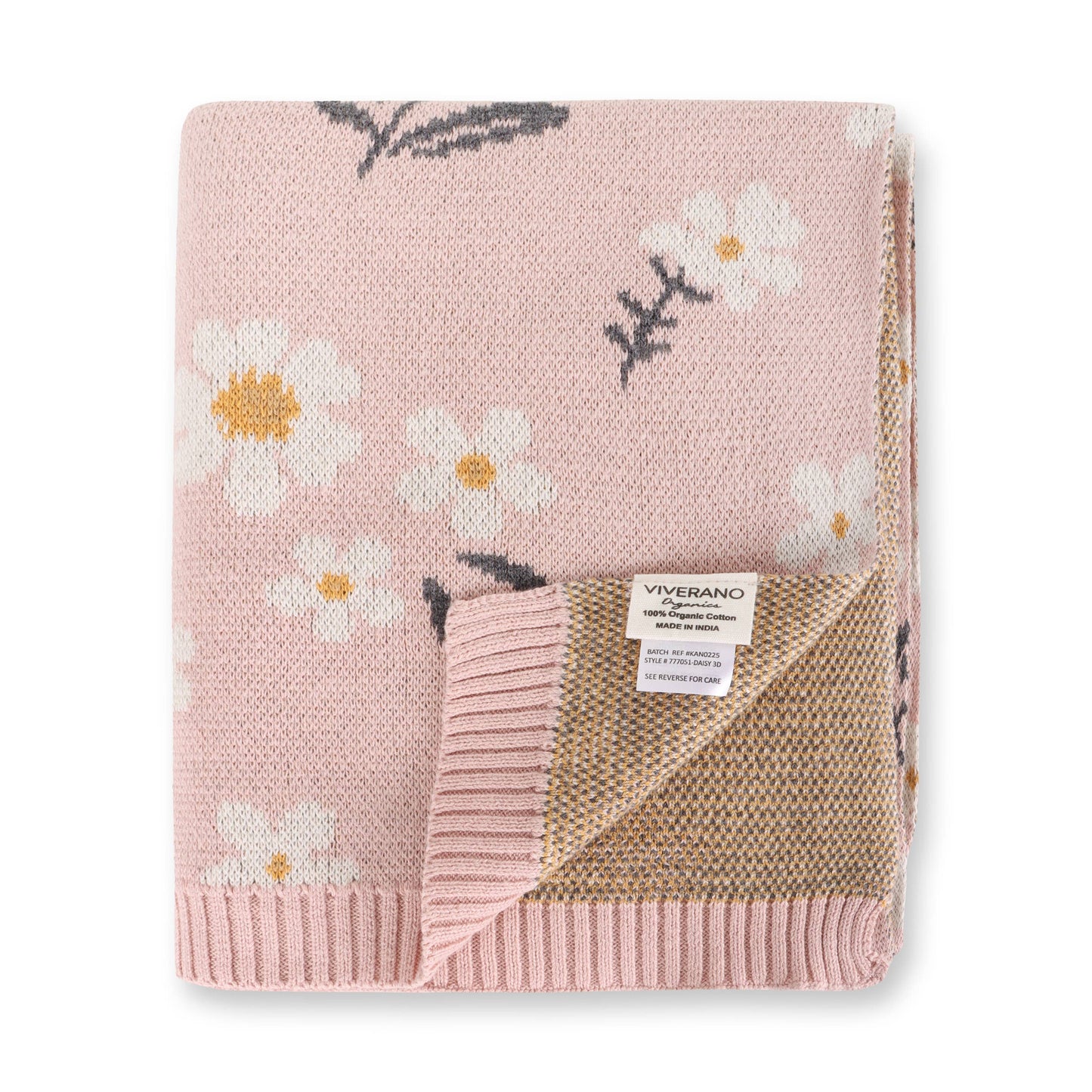 Pink floral-patterned blanket with a visible brand label on a white background