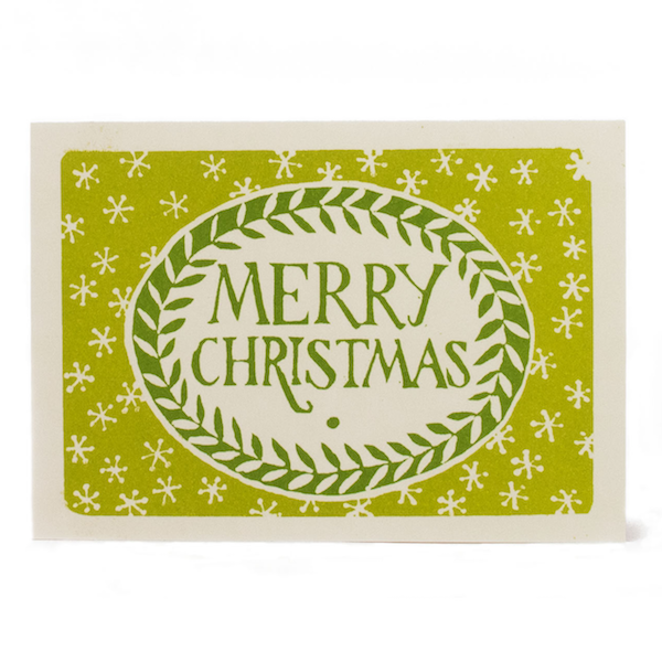 Sap and green Merry Christmas greeting card with a leafy oval wreath and small star motifs.