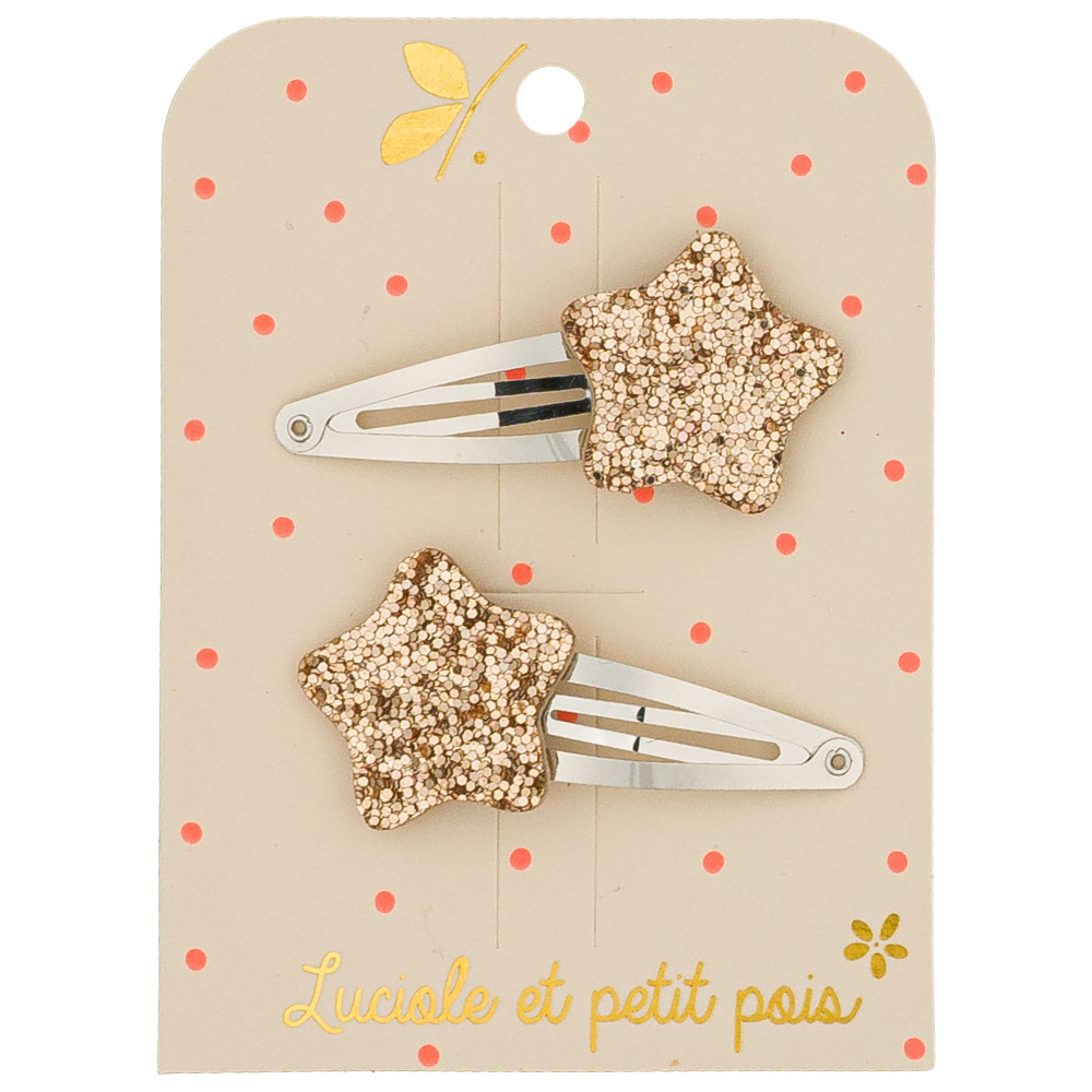 Two star-shaped hair clips on a beige card with red polka dots and floral designs, featuring the brand 'Lucile et petit pois'.