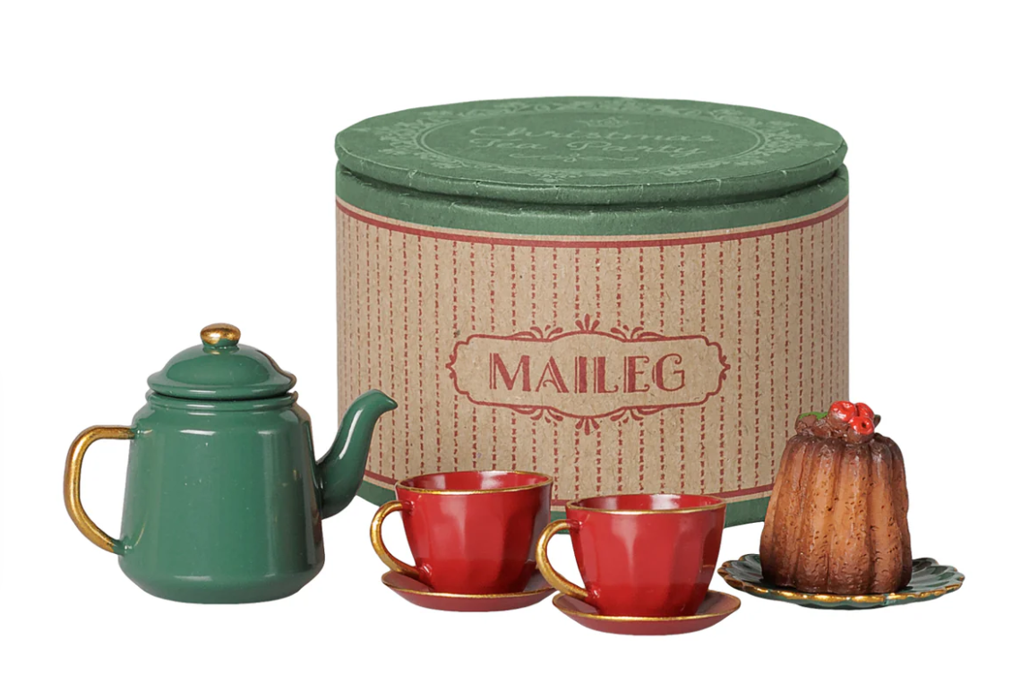 Miniature tea set with red cups and saucers, a bundt cake, and a green teapot, next to a round box with Maileg branding