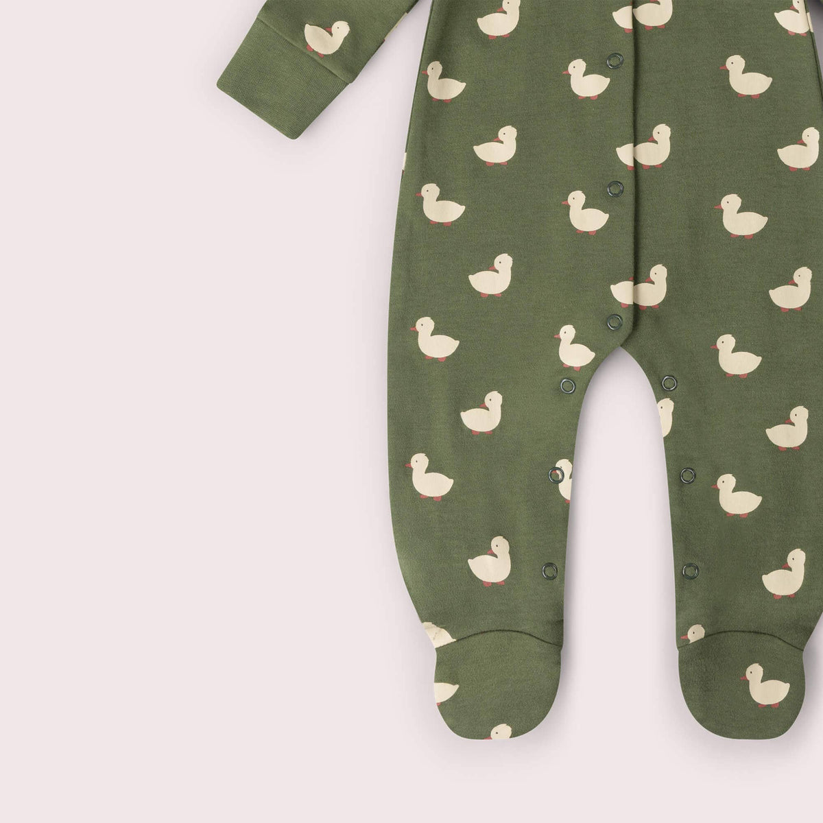 Detail of the sleeves and duck pattern on an olive green babygrow.