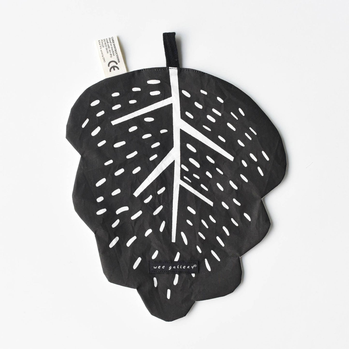 Black leaf-shaped product with white details on a white background