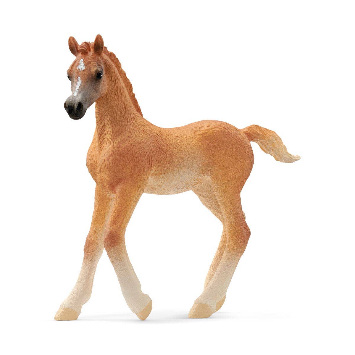 A toy figurine of a brown and white Arabian foal horse.