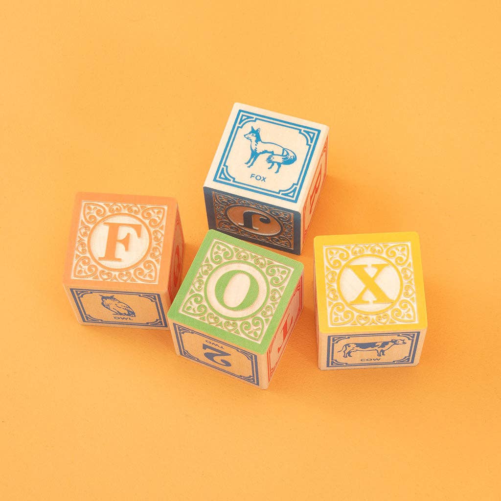 Set of wooden blocks with letters on a yellow background