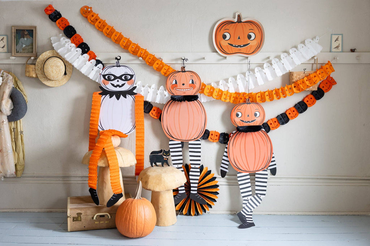 All three paper jackolanterns in a room with other Halloween decor