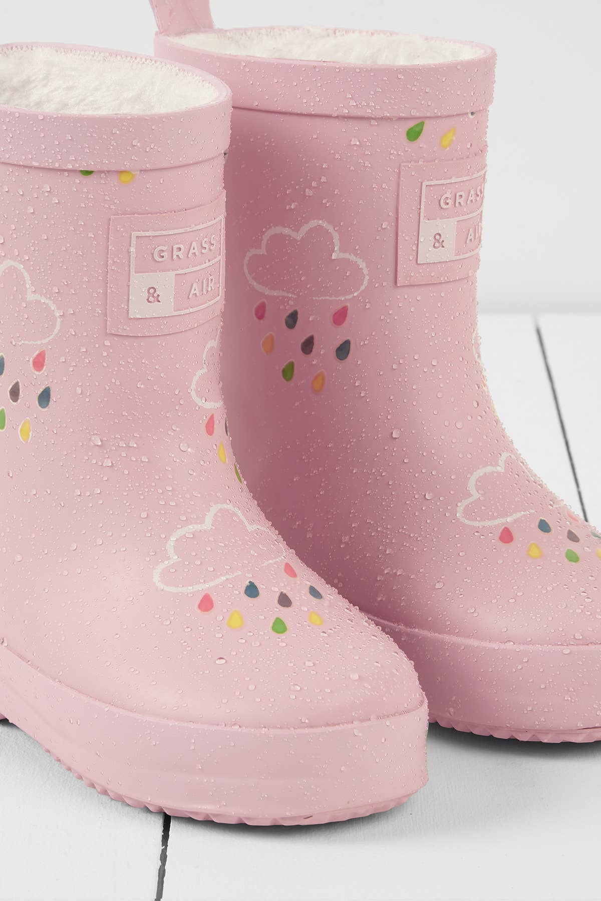 pink rainboots with raindrops on them with a raindrop and cloud pattern