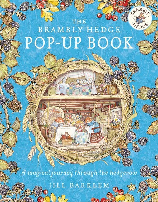 Cover of 'The Brambly Hedge Pop-Up Book' with colorful illustrations and a blue background.