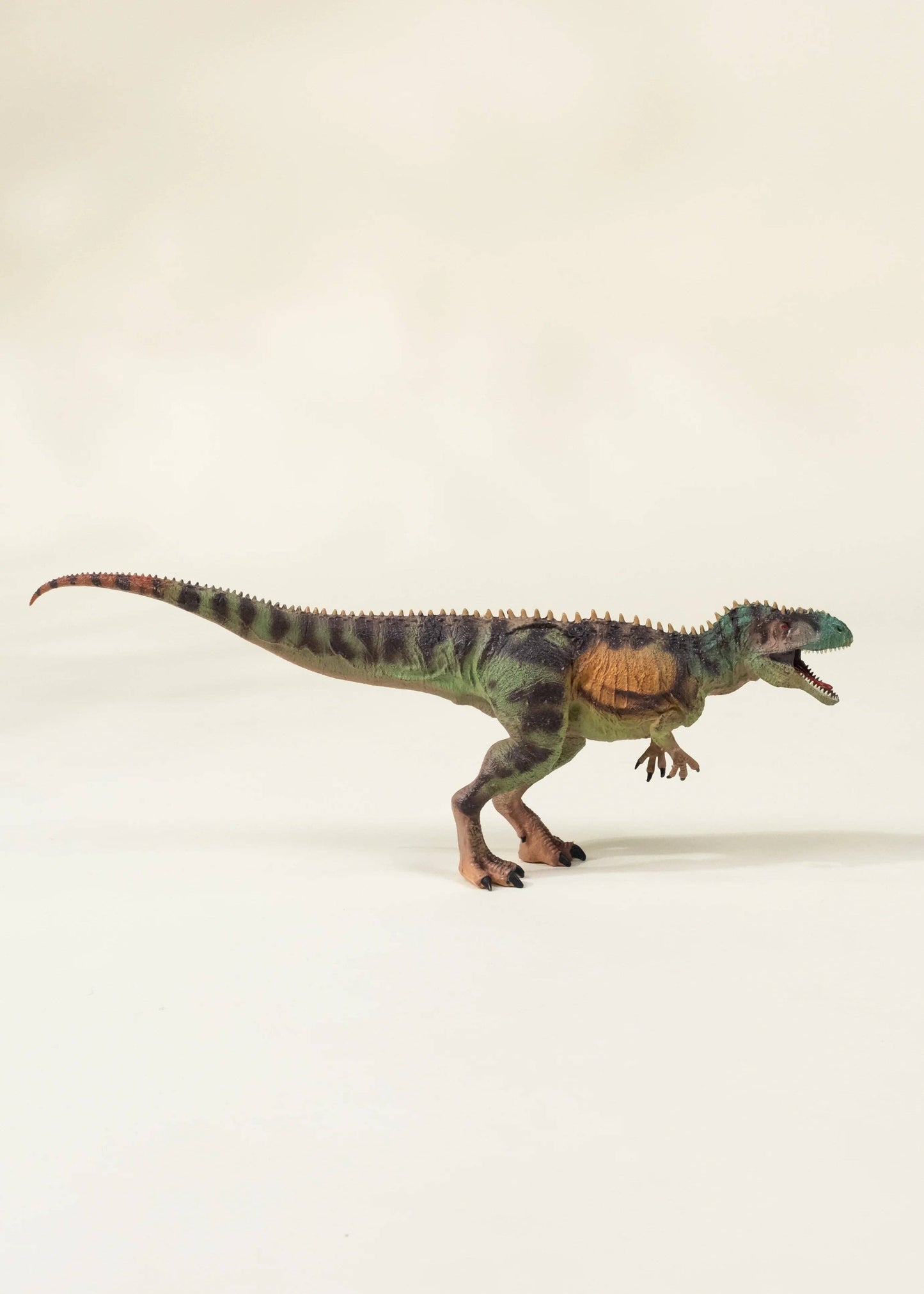 Dinosaur toy model on a plain background
