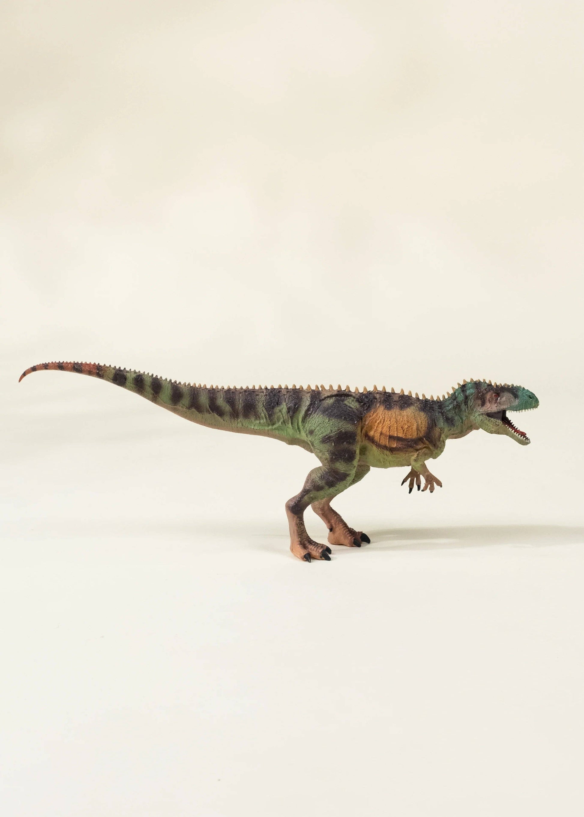 Dinosaur toy model on a plain background