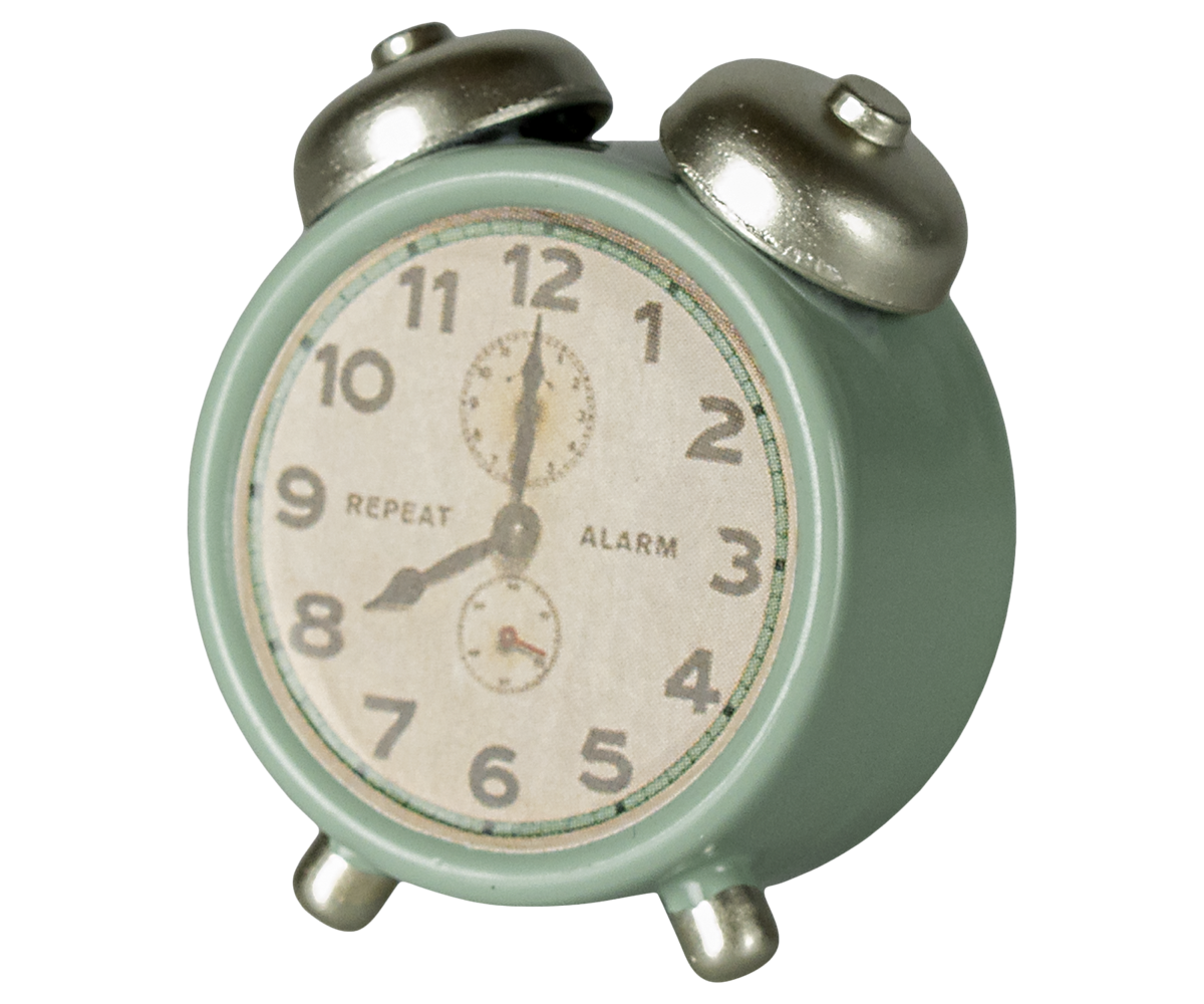 Vintage-style alarm clock with a light green casing and silver bells on a white background