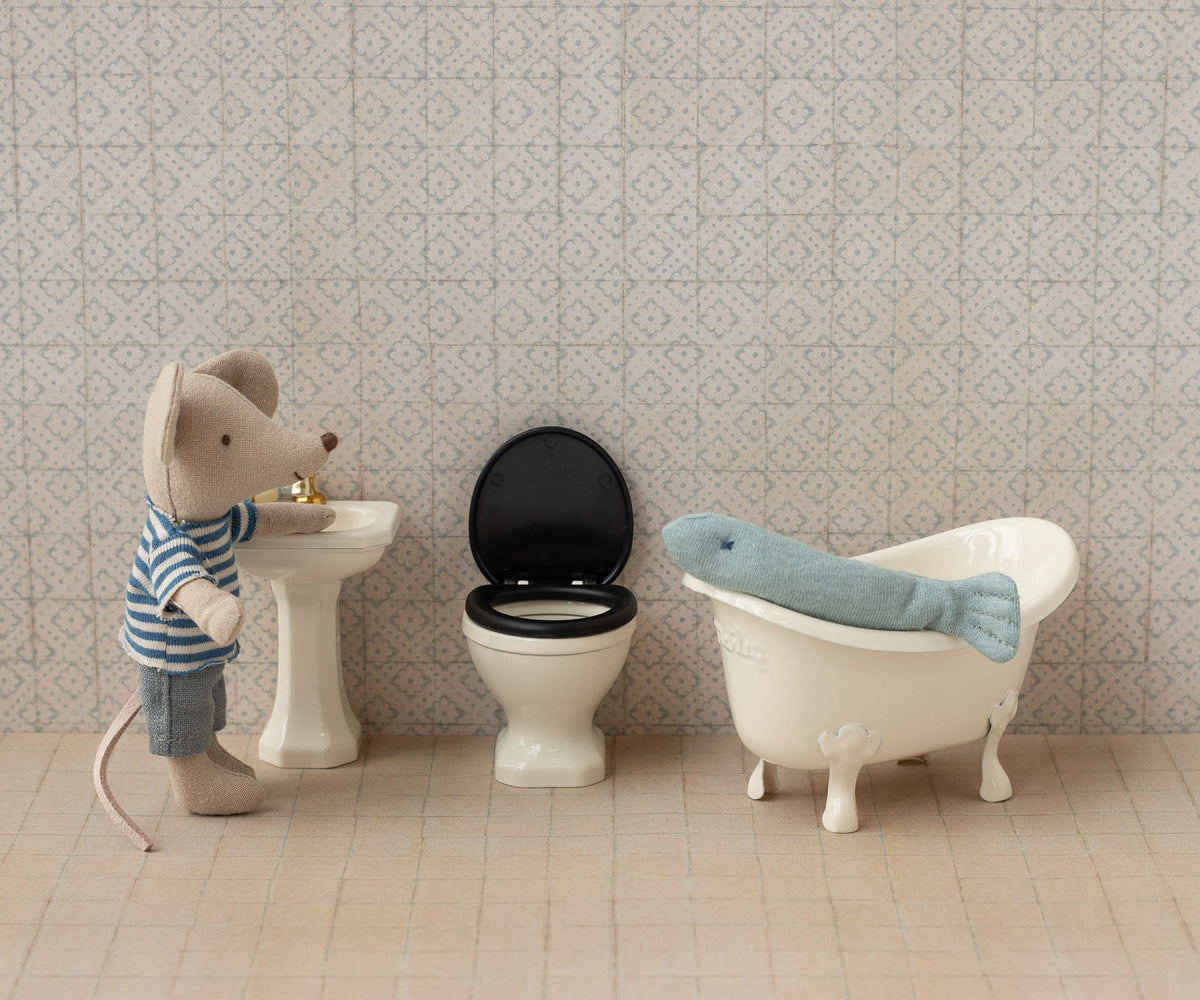 Maileg mouse in bathroom setting with pedestal sink, toilet, and tub with whale toy