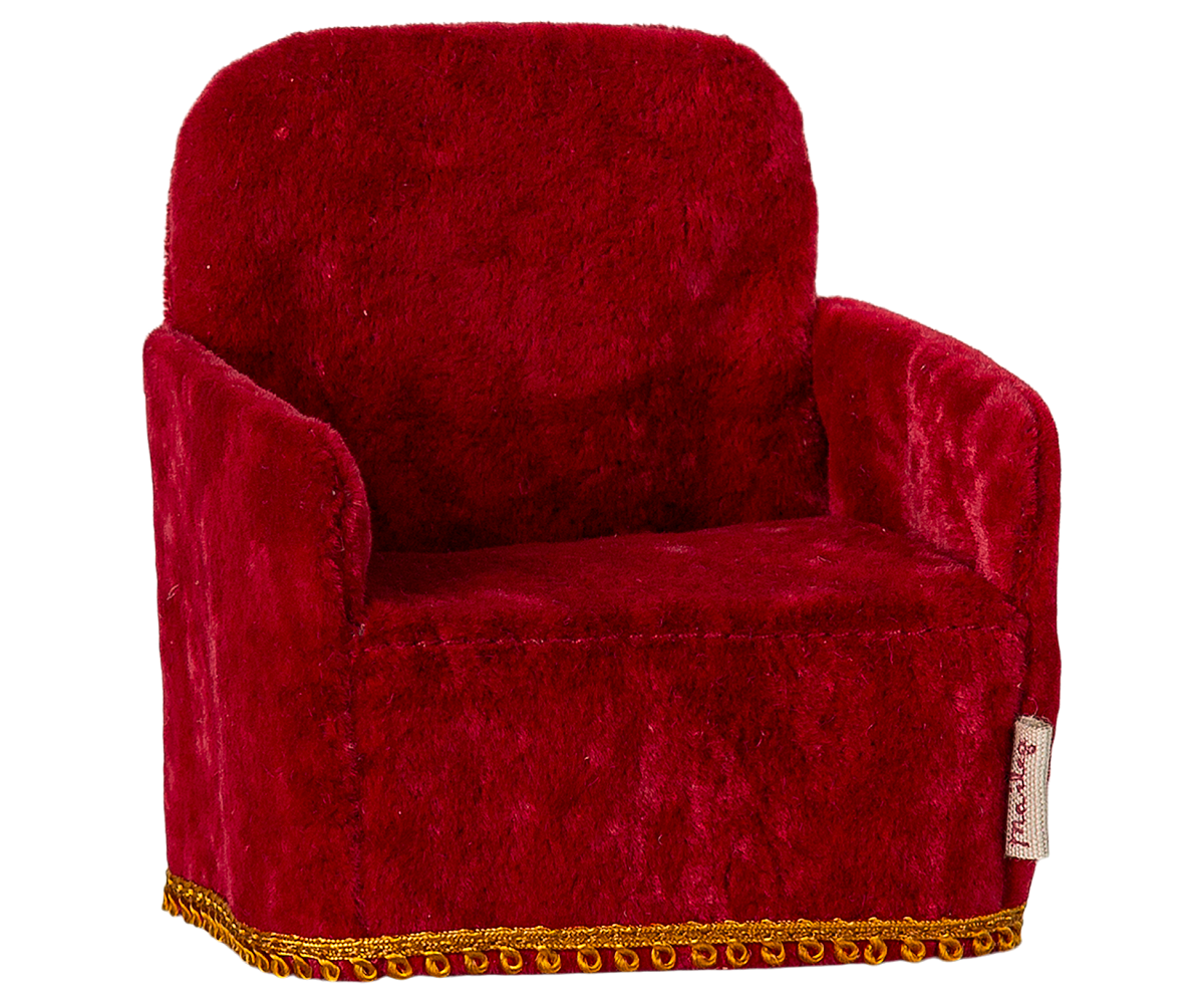 Red velvet dollhouse armchair with gold trim on a white background