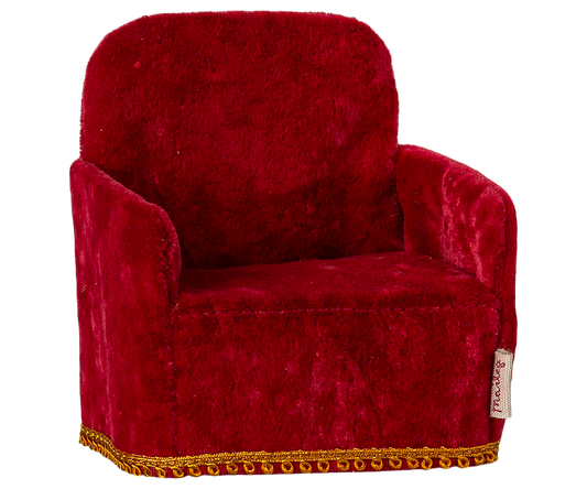 Red velvet dollhouse armchair with gold trim on a white background