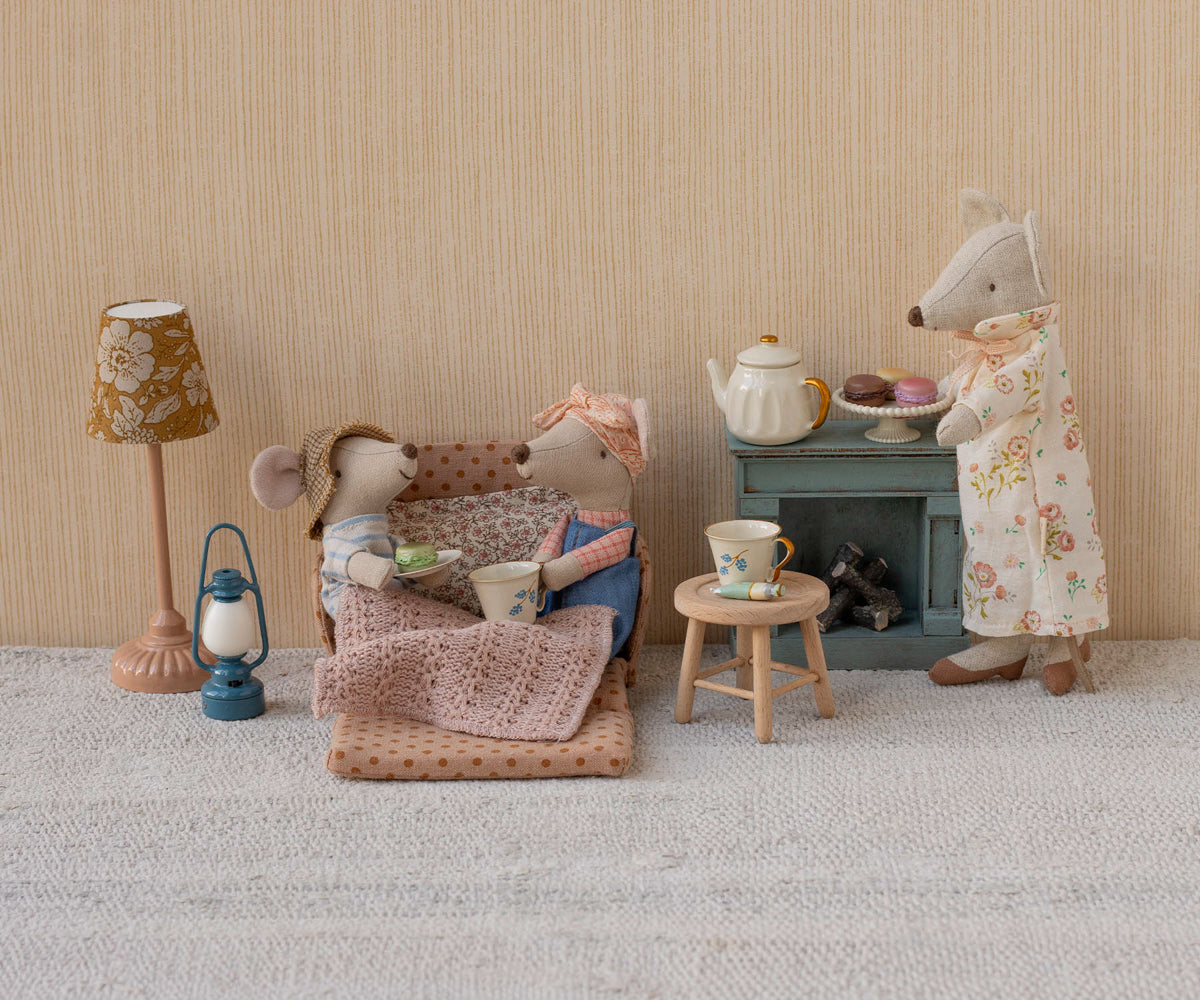 Maileg mice in living room setting with orange polka dotted dollhouse couch and other living room furniture with tea cups