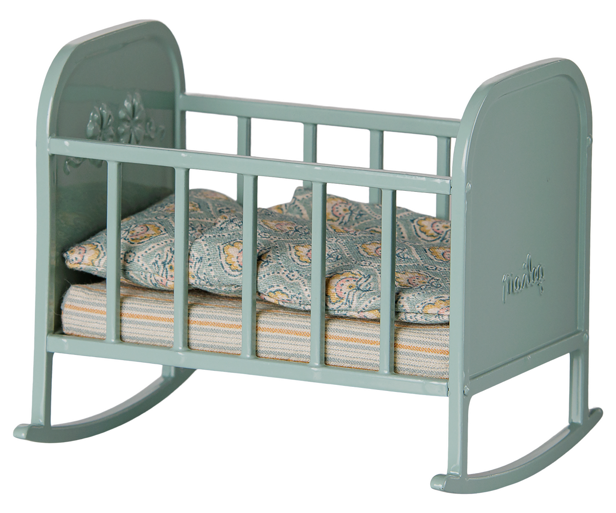 Blue Maileg crib for mouse dolls with a striped cribsheet and floral pillow and comforter