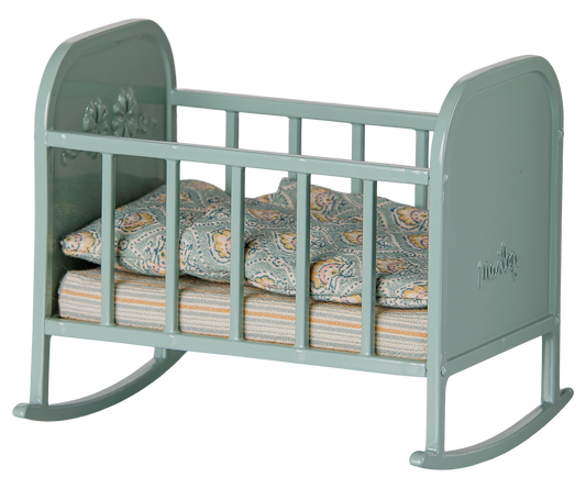 Blue Maileg crib for mouse dolls with a striped cribsheet and floral pillow and comforter