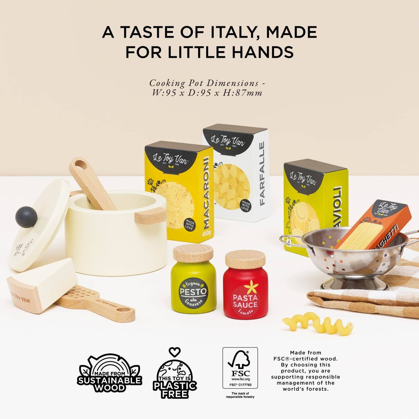 Miniature kitchen set with cooking pots, pasta boxes, and condiment jars on a white background.