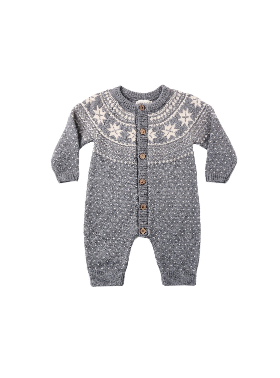 A baby knit romper in gray and white, featuring a Fair Isle style snowflake pattern across the chest and small white dots throughout, with brown buttons down the front.