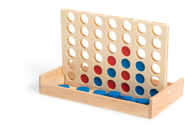 Wooden game board with red and blue discs on a white background