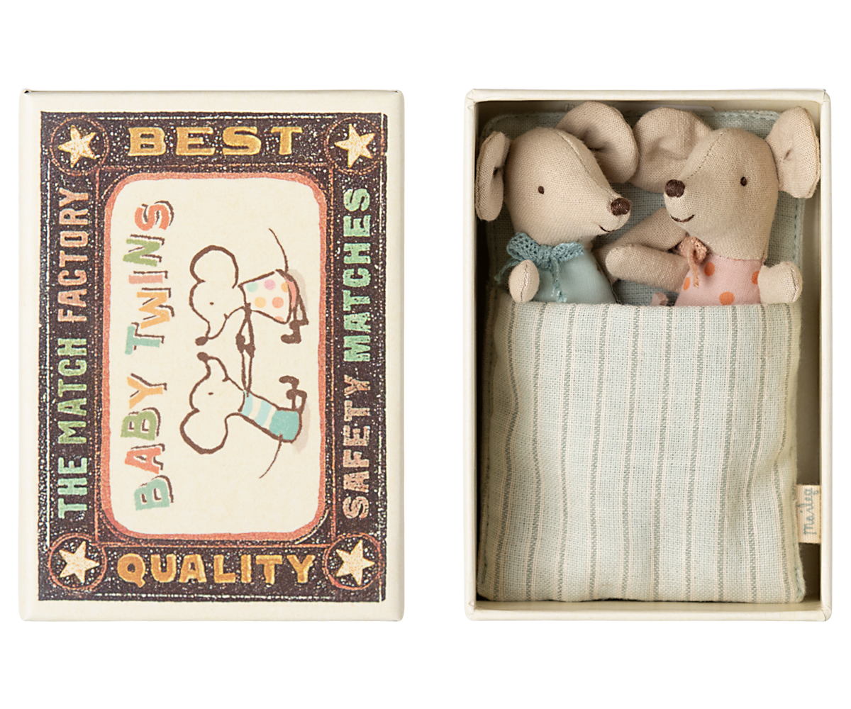 Two stuffed animal toys in a matchbox with a vintage-style label.