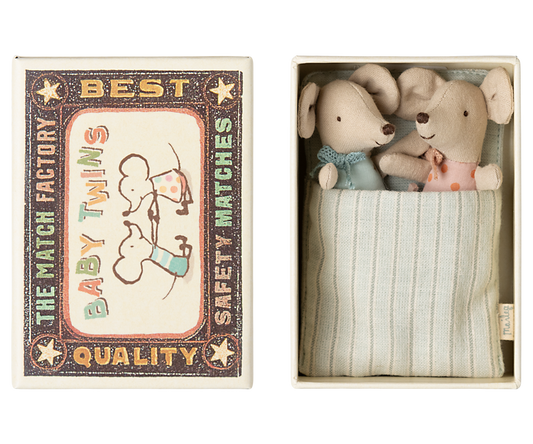 Two stuffed animal toys in a matchbox with a vintage-style label.