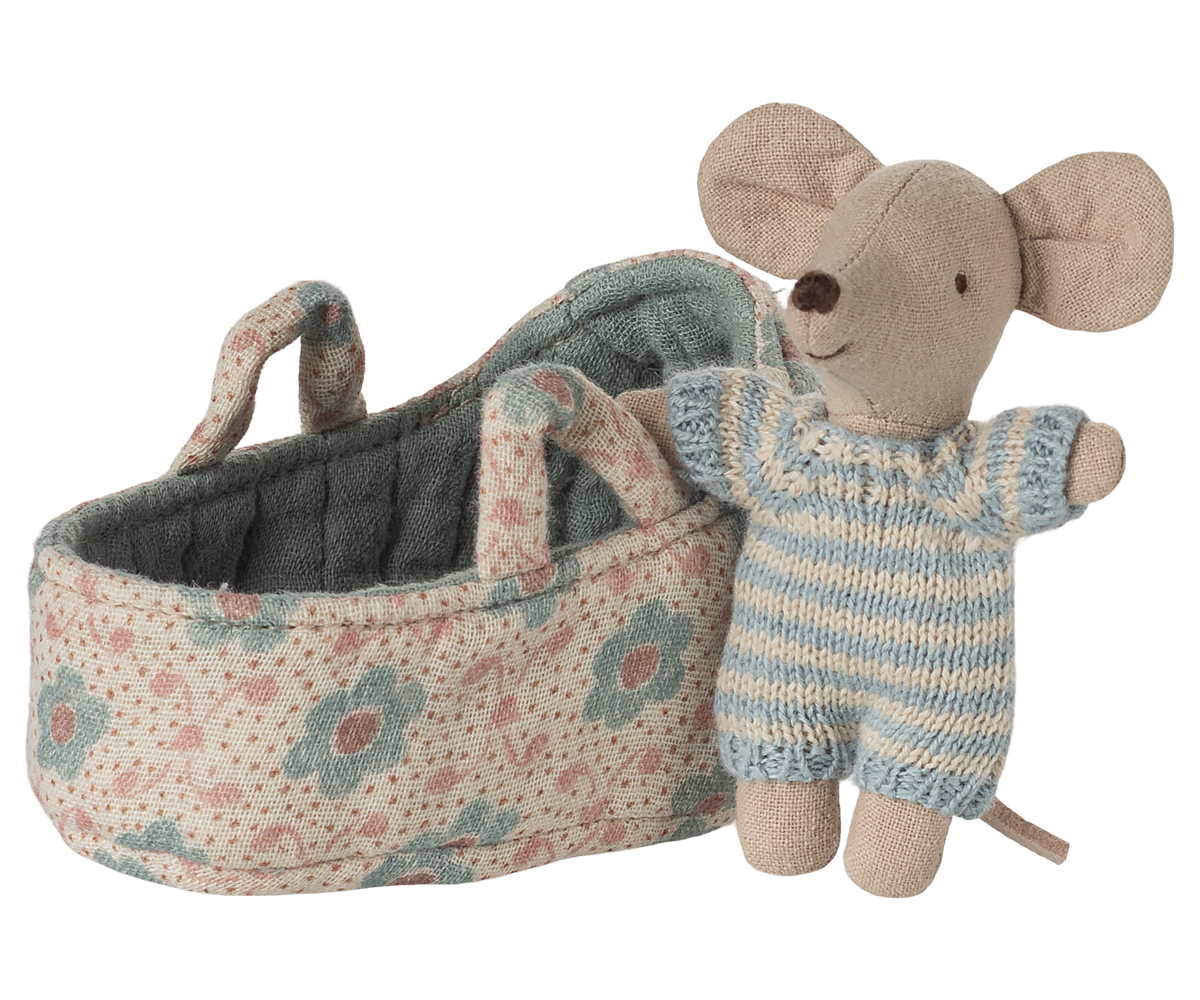 Toy mouse in a floral-patterned crib on a white background
