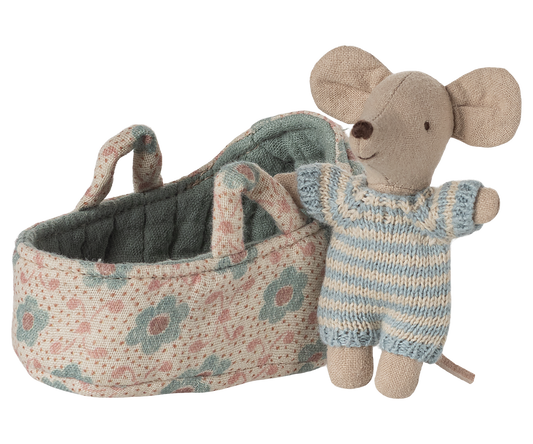 Toy mouse in a floral-patterned crib on a white background