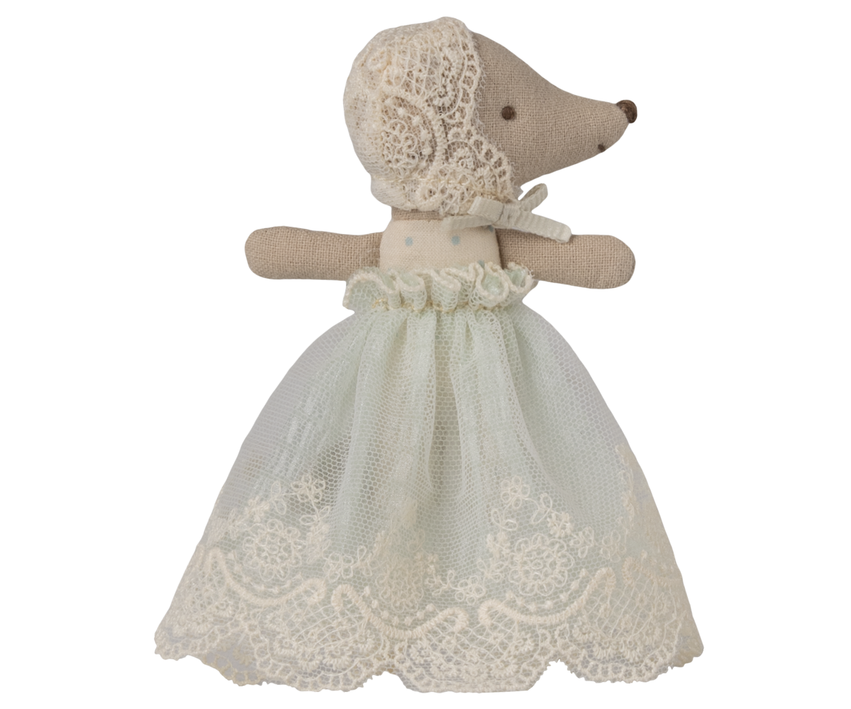 Stuffed animal toy with a lace dress on a white background, with eyes open