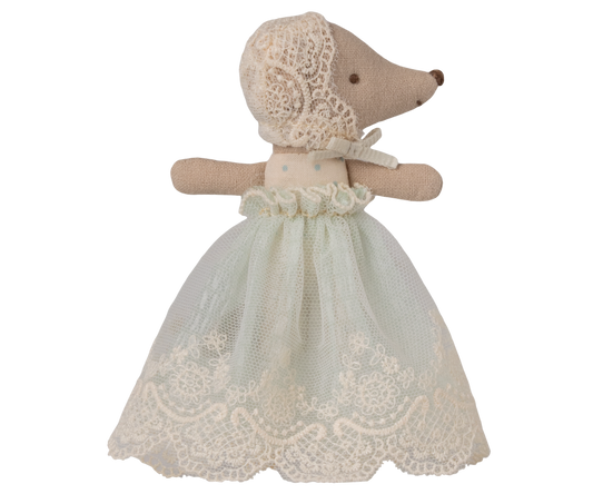 Stuffed animal toy with a lace dress on a white background, with eyes open