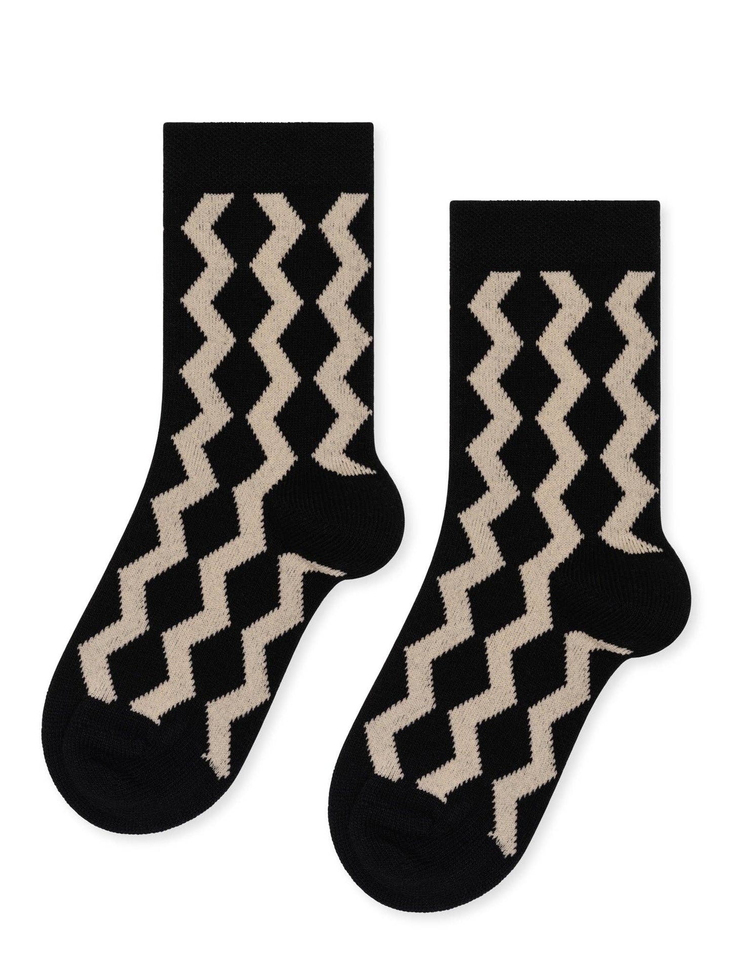 Pair of black socks with beige zigzag pattern on a white background