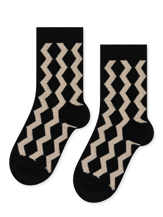 Pair of black socks with beige zigzag pattern on a white background