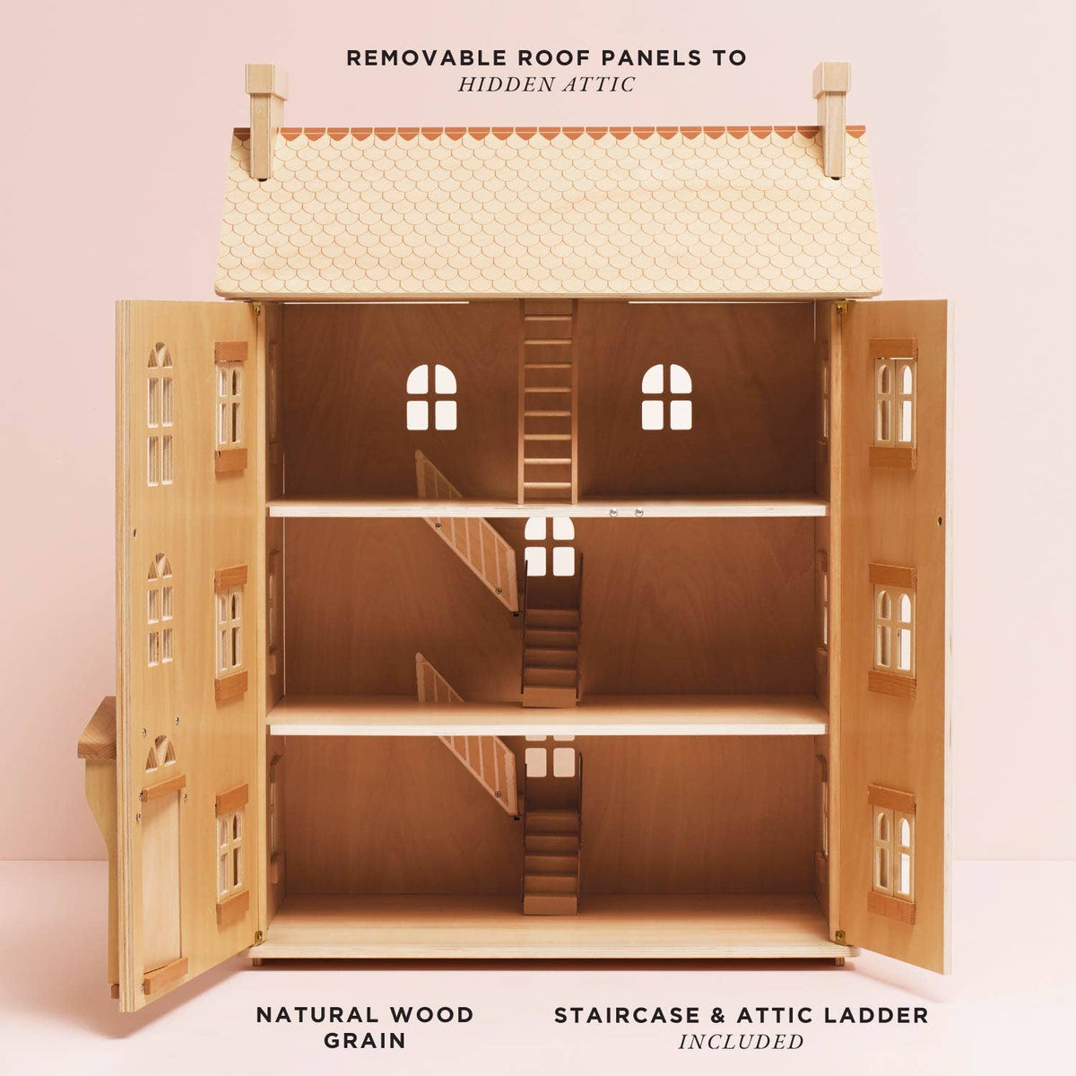 Wooden dollhouse with removable roof panels on a pink background