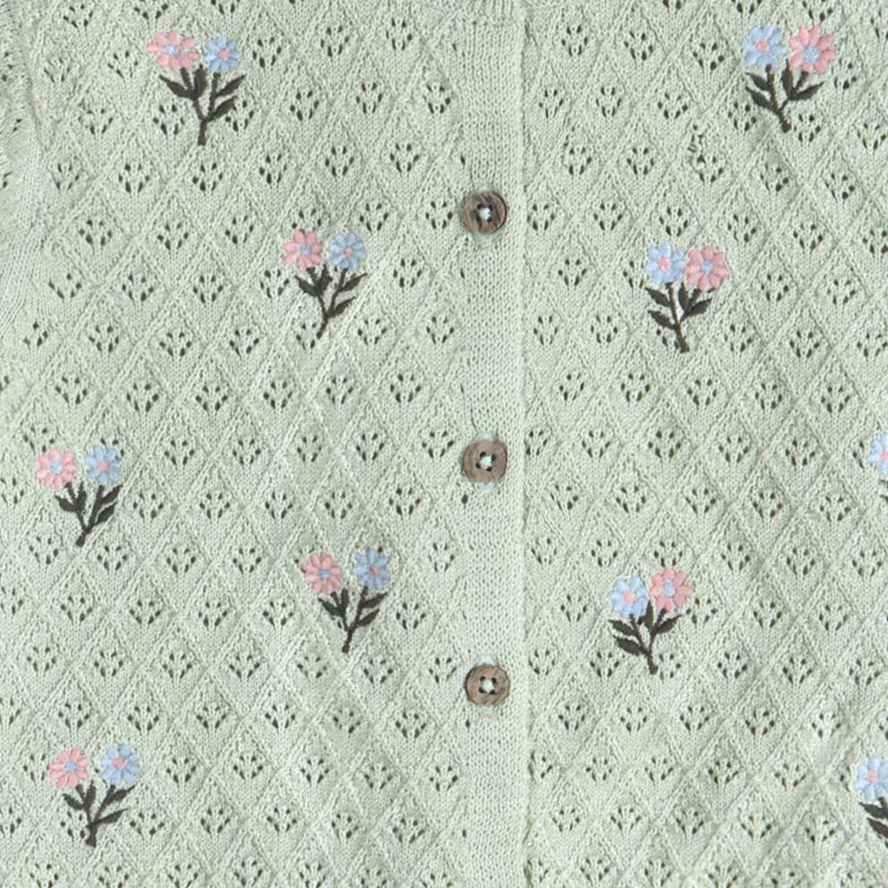Light green knitted cardigan with floral patterns and buttons