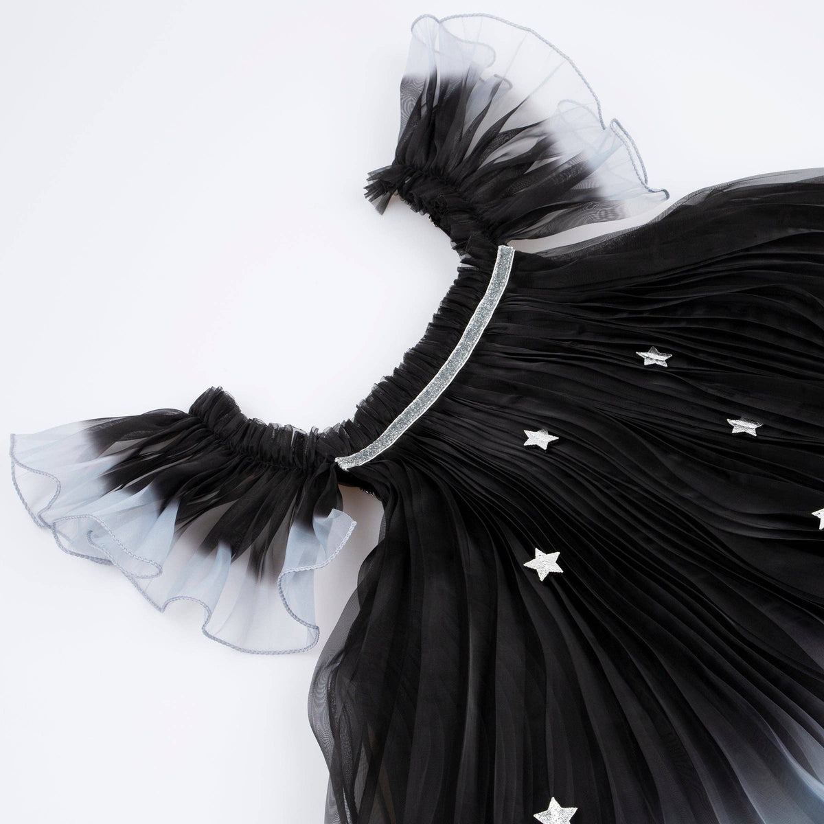 Black dress with star details on a white background