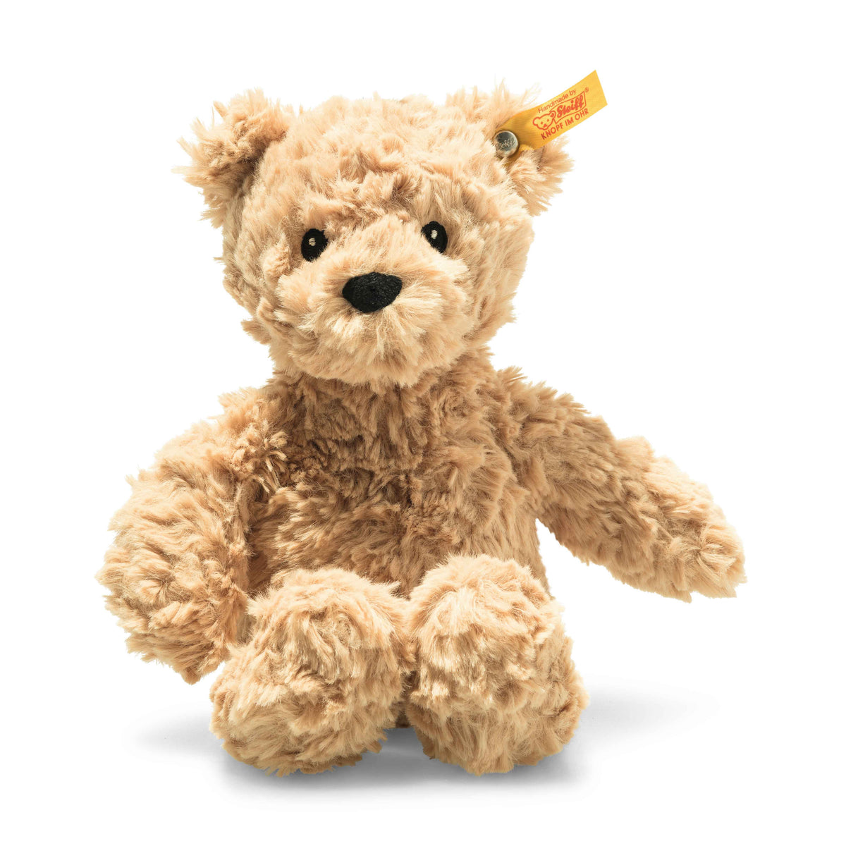 Tan steiff teddy bear on a white background