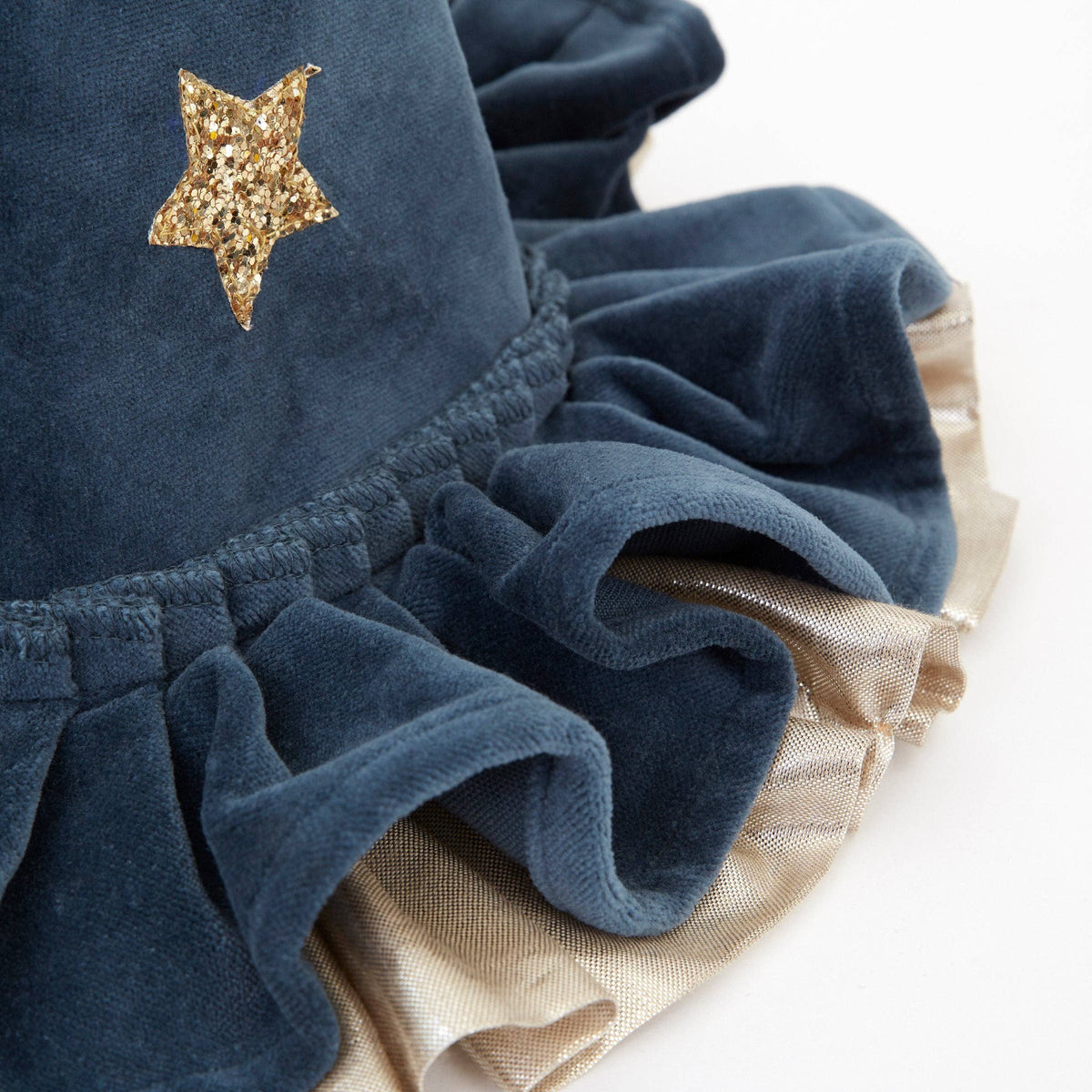 Navy blue velvet hat with gold star detail on a white background