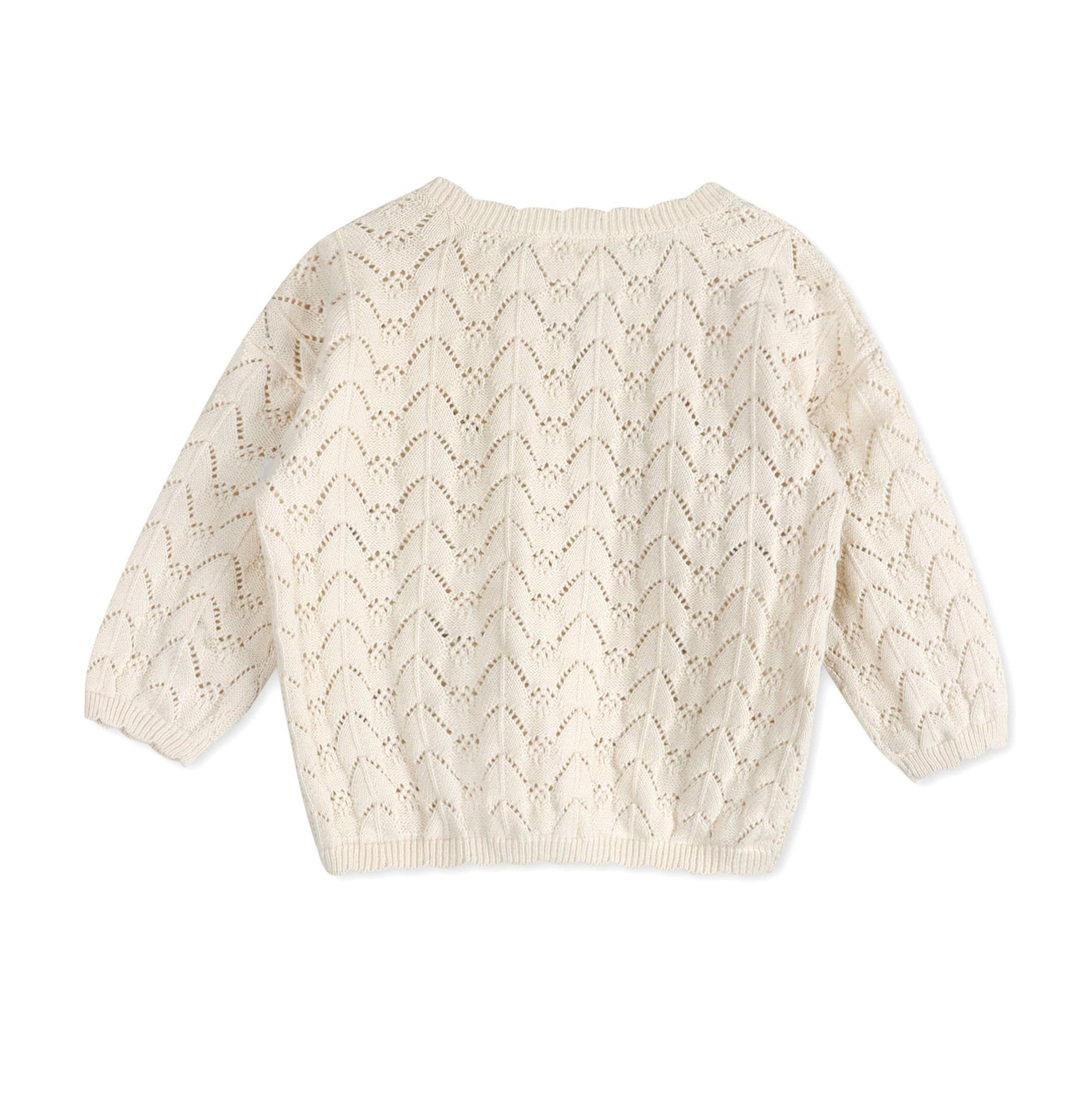 Back of cream-colored knitted sweater on a white background