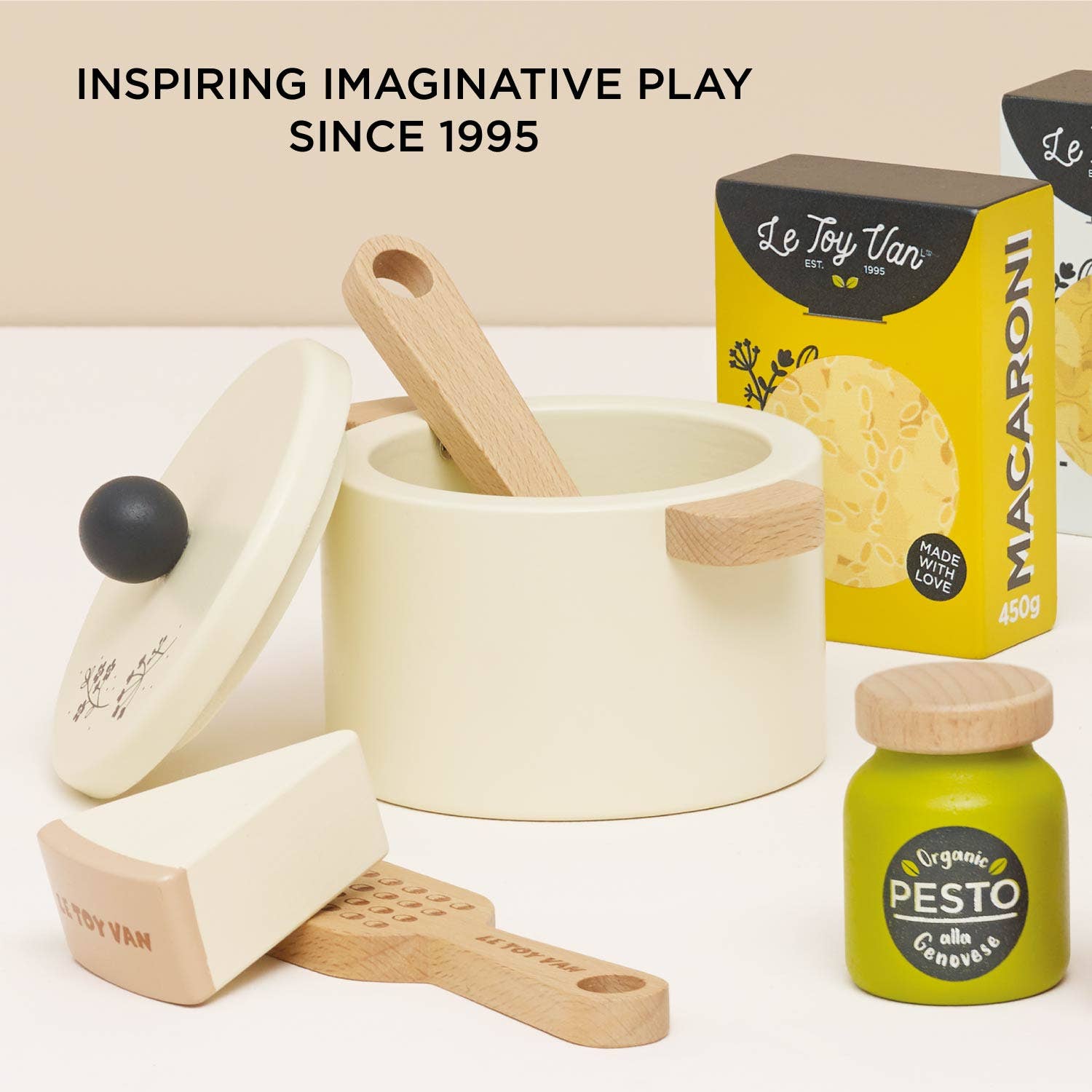 Children's wooden kitchen tool play set with pots, pans, and a box of macaroni, featuring Le Toy Van branding.