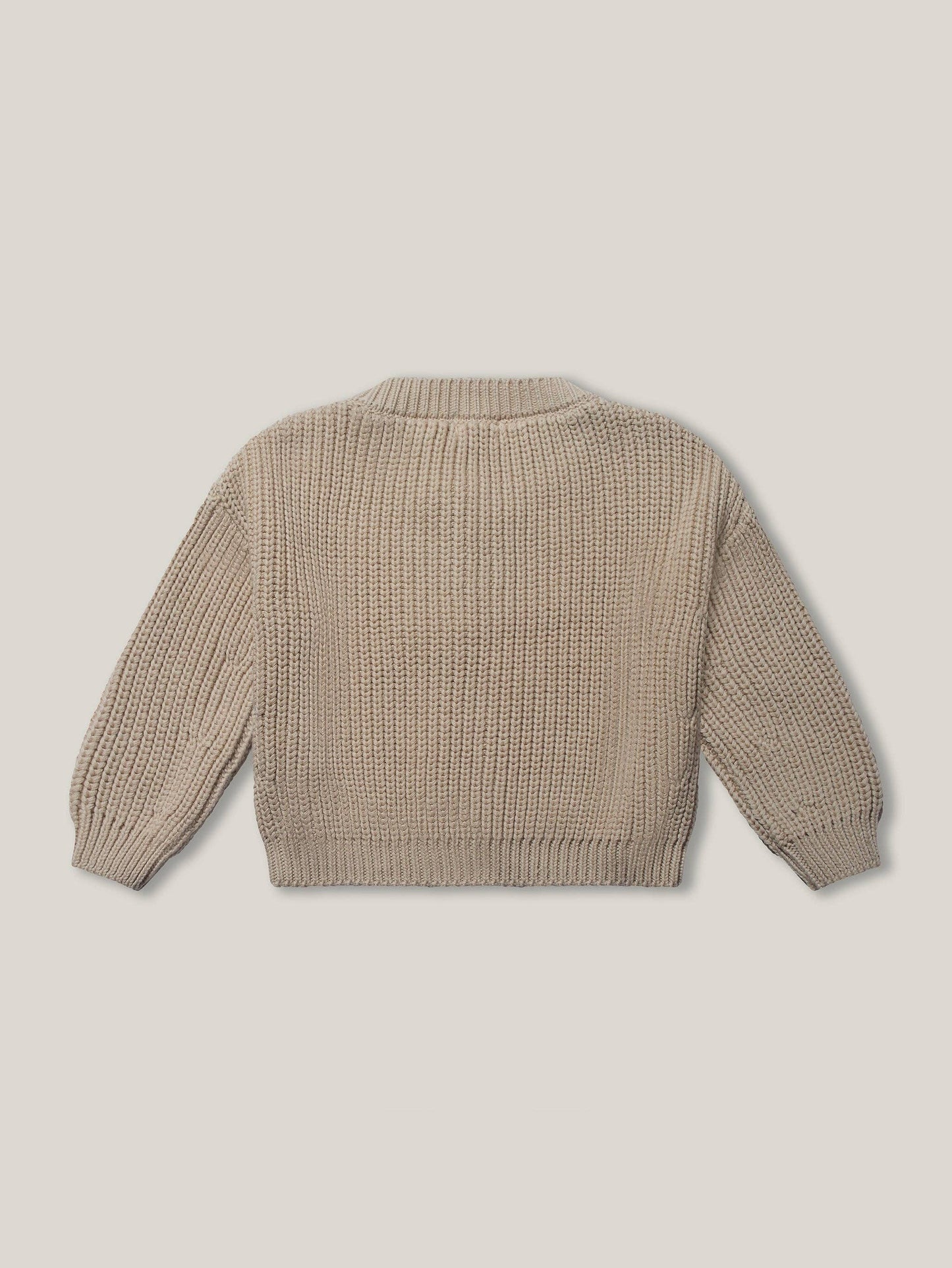 Back view of beige knitted sweater on a light beige background