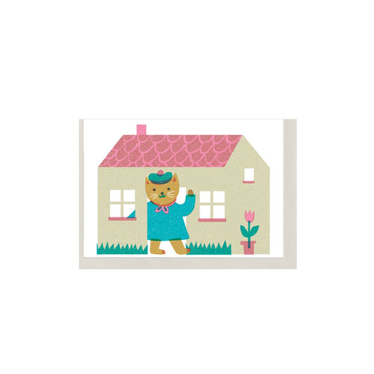 Illustration of a cat in a blue coat standing in front of a pink-roofed house on a white background.