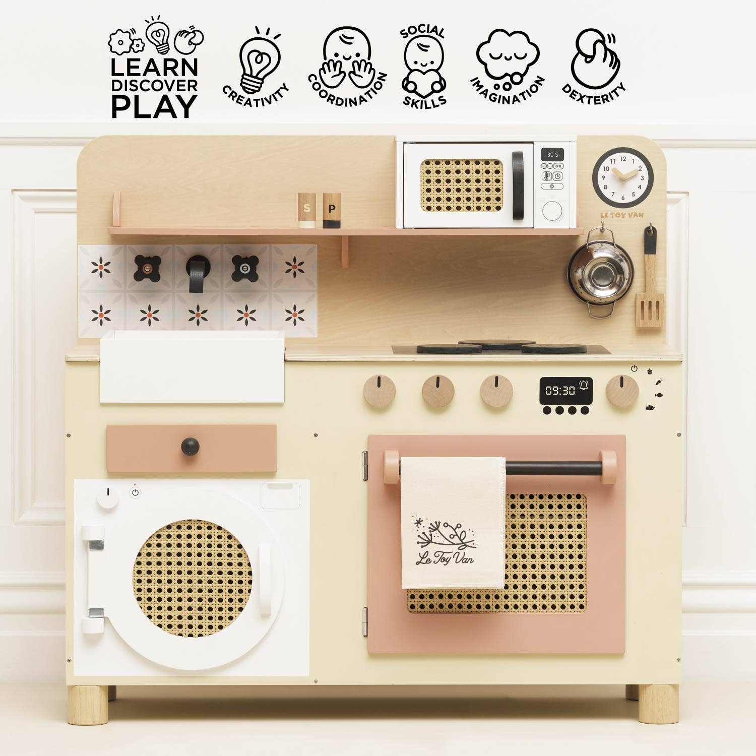 Wooden toy kitchen set with various appliances on a white background
