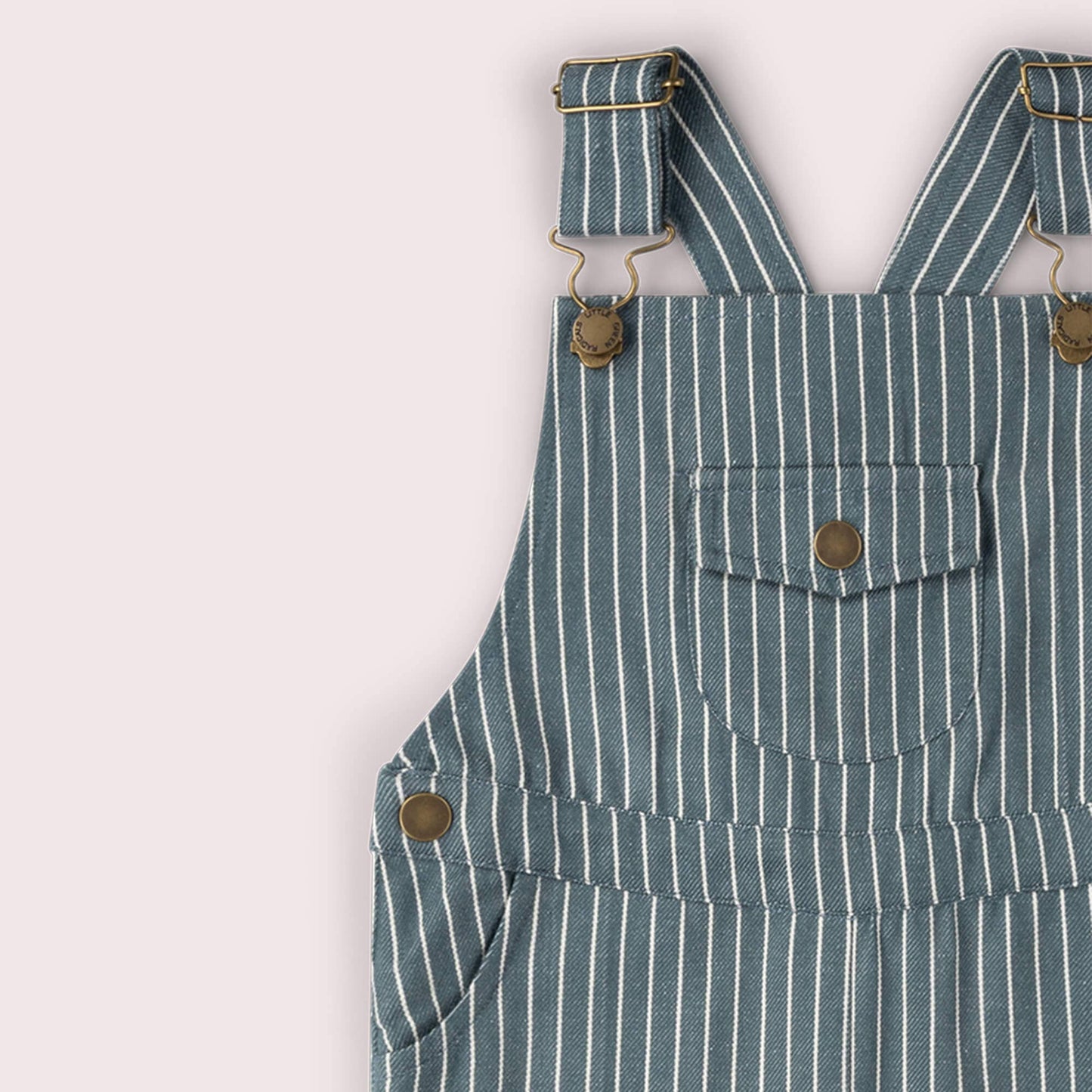 Blue and white striped overalls with button details on a light gray background