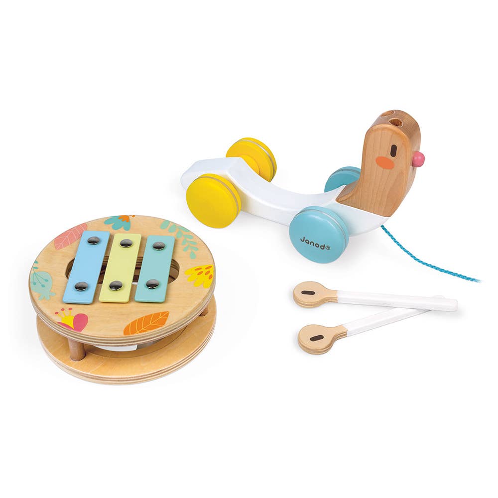 Set of wooden toys including a xylophone, rattle, and teether on a white background