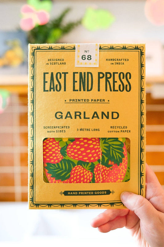 Handheld package of East End Press printed paper garland with a colorful design.