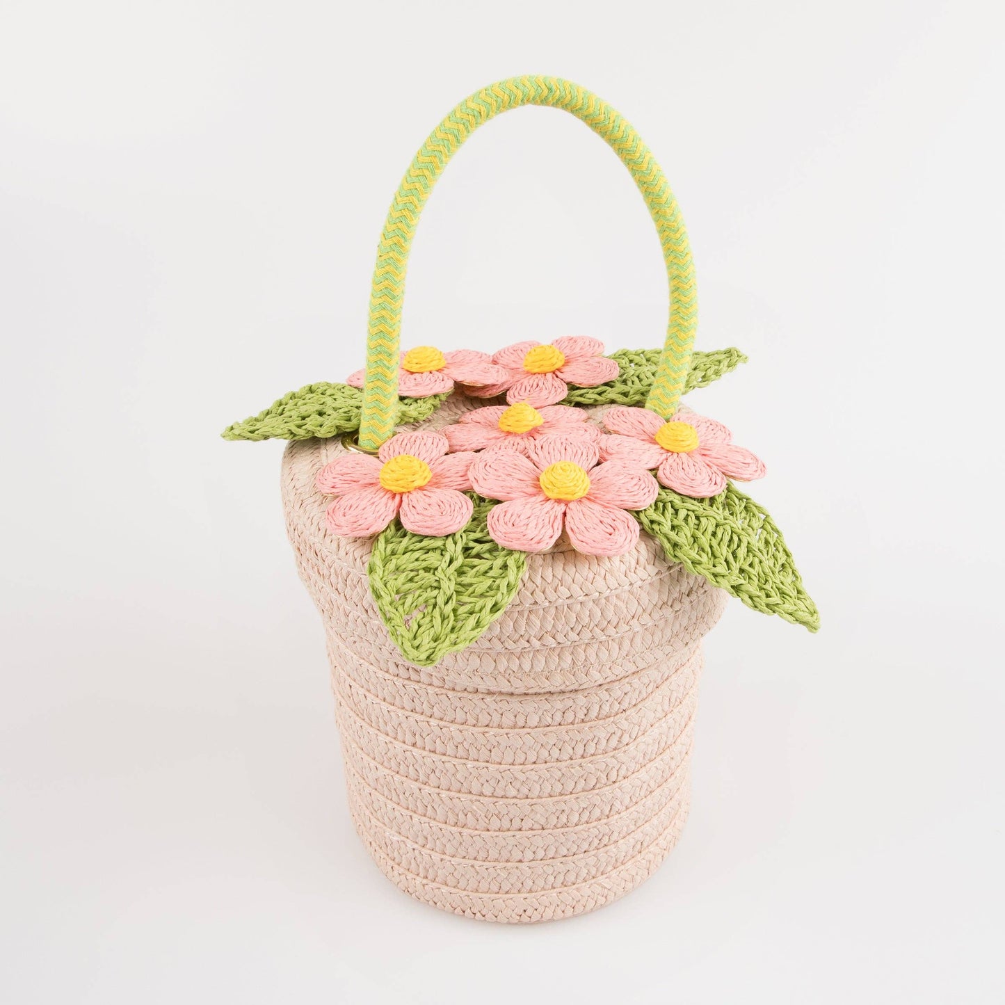 Crocheted basket with floral decorations on a white background